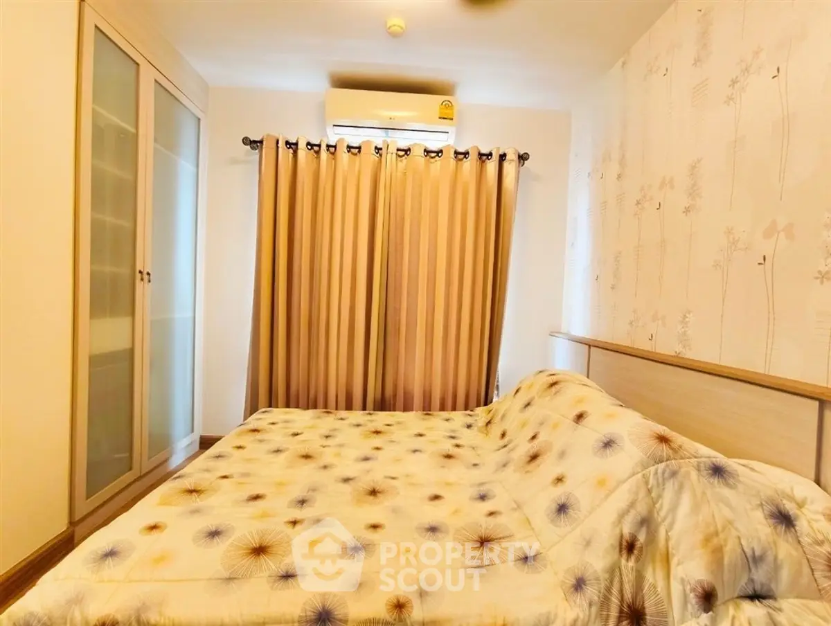 Cozy bedroom with stylish decor and ample natural light, featuring a large wardrobe and elegant curtains.