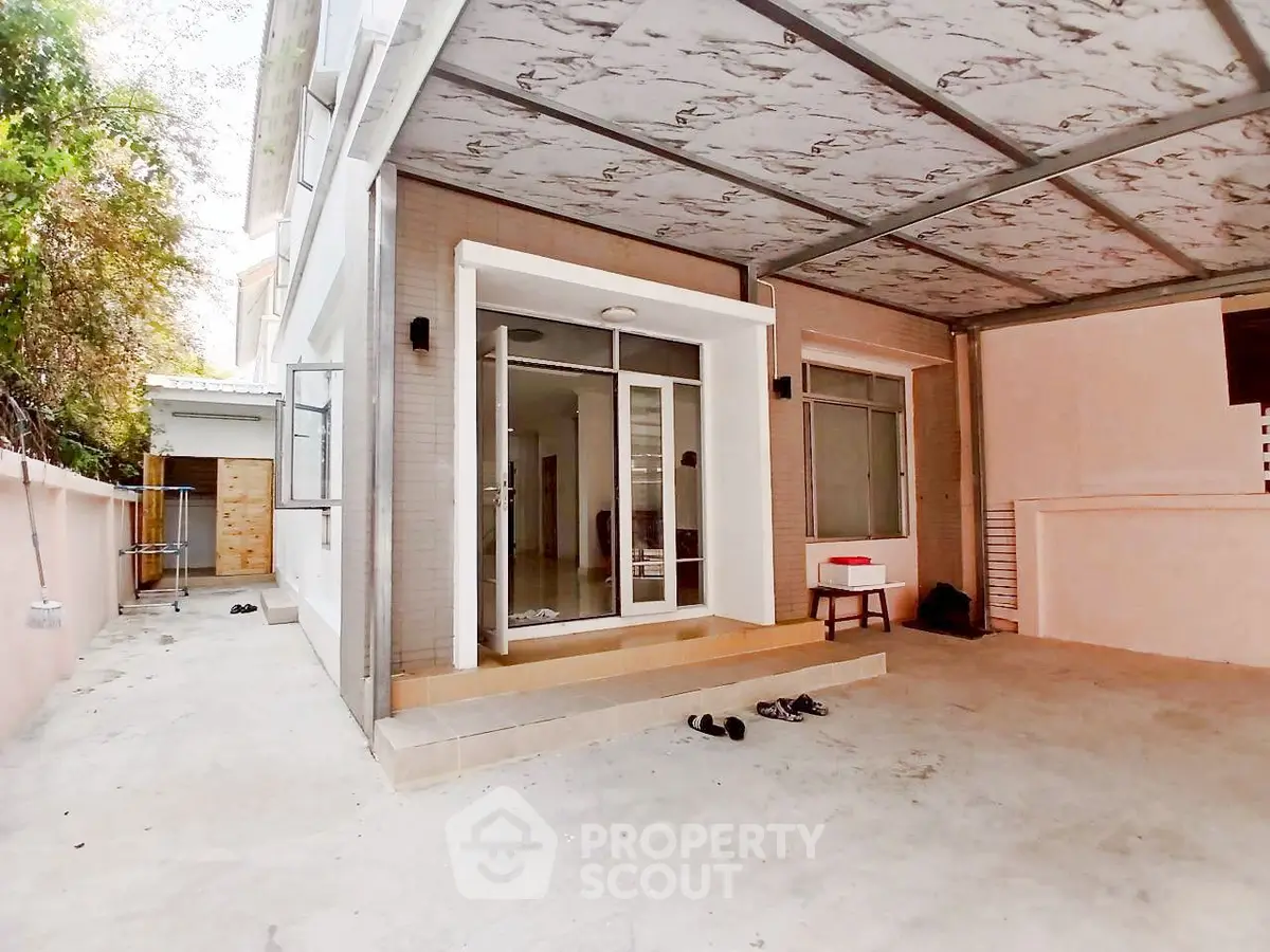 Spacious modern home exterior with covered patio and sliding glass doors