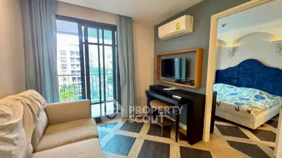 Chic apartment with modern living room and cozy bedroom, featuring stylish decor and a balcony view.