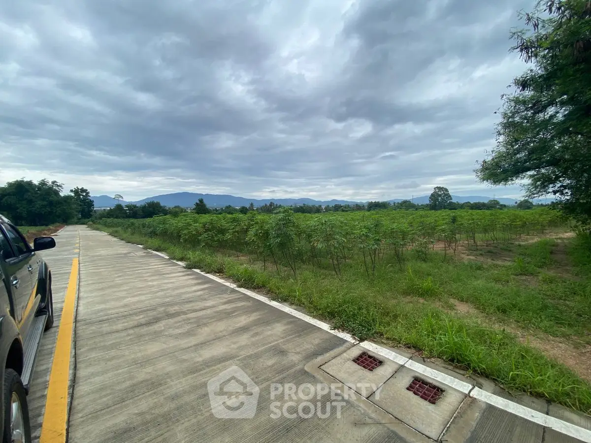 Expansive land plot with scenic mountain views and lush greenery, ideal for development or investment.
