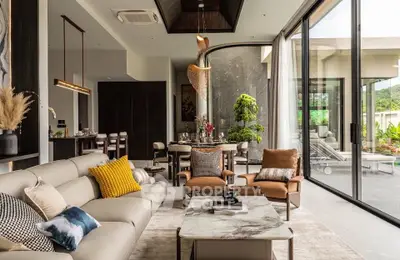 Luxurious modern living room with elegant decor and large glass doors opening to a scenic view.