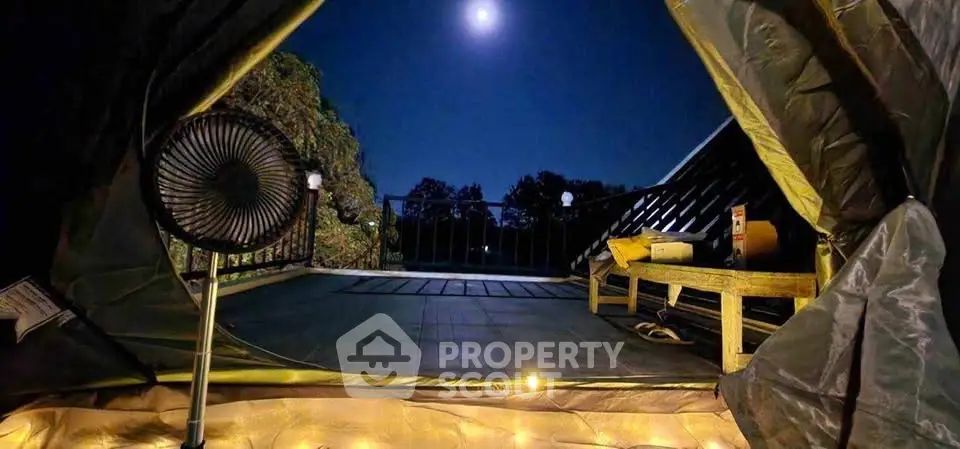 Charming rooftop terrace with cozy tent setup under moonlit sky, perfect for stargazing and relaxation.
