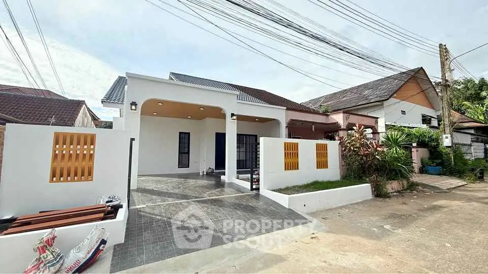 Charming single-story house with modern facade and spacious driveway in a serene neighborhood.
