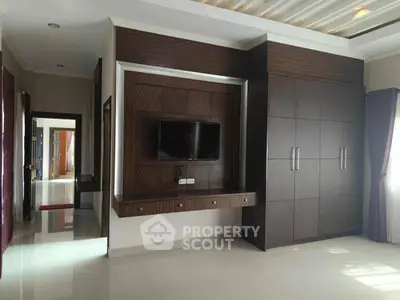 Spacious modern living room with built-in TV unit and ample storage