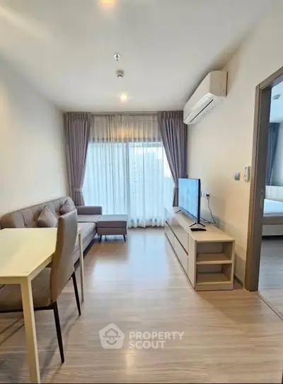 Modern living room with sleek furniture and natural light, perfect for urban living.