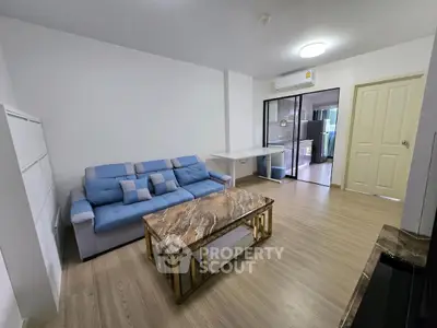 Modern living room with stylish sofa and marble coffee table in a cozy apartment.