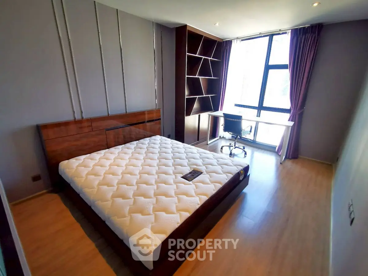 Spacious bedroom with modern design and large window for natural light