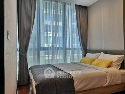 Modern bedroom with large window and elegant curtains in a high-rise apartment.