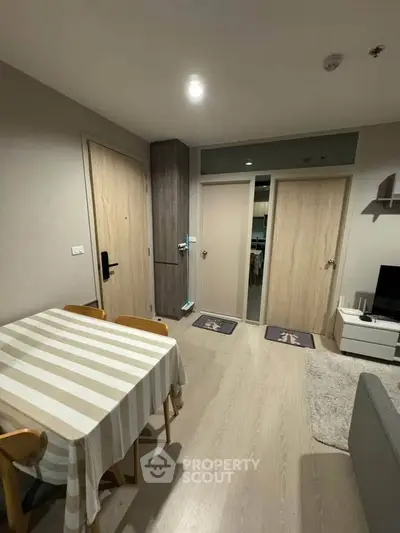 Cozy living room with dining area and modern decor in a stylish apartment.