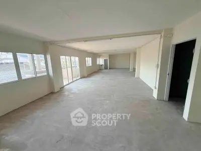 Spacious open-plan interior with large windows and ample natural light, ideal for customization.