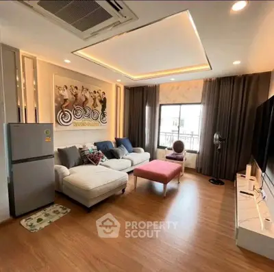 Spacious living room with modern decor and large window view