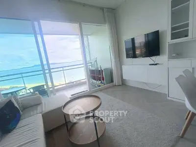 Stunning beachfront living room with panoramic ocean views and modern decor.