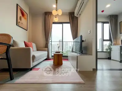 Modern living room with stylish decor and city view, featuring a cozy sofa and large window.