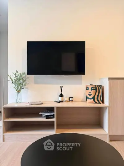 Modern living room with wall-mounted TV and stylish wooden cabinet