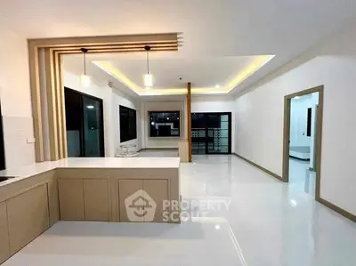 Spacious modern kitchen with open layout and elegant lighting in a contemporary home.