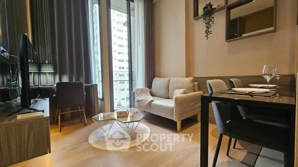 Modern living room with stylish decor and large windows in a high-rise apartment.