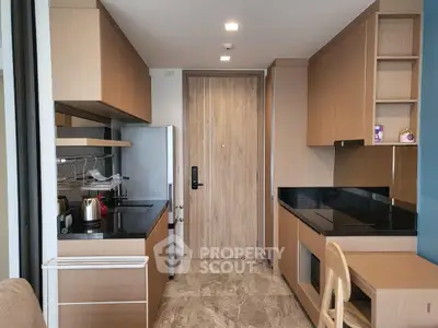 Modern kitchen with sleek wooden cabinetry and black countertops