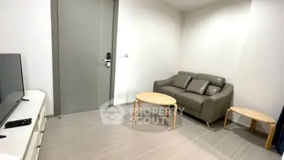 Modern living room with sleek furniture and neutral tones, perfect for cozy urban living.