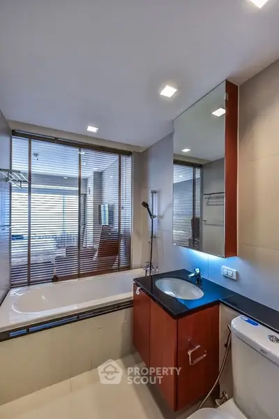 Modern bathroom with sleek design and bathtub in luxury apartment
