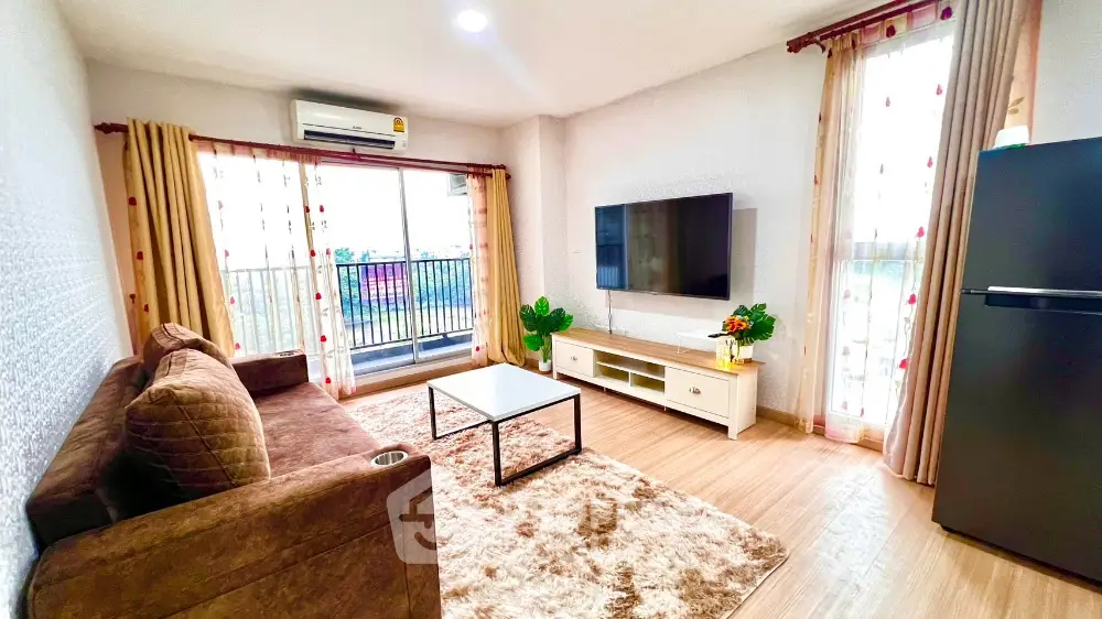 Spacious living room with modern decor and balcony access