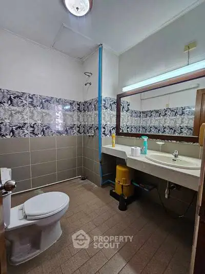 Spacious bathroom with modern fixtures and stylish tile design.