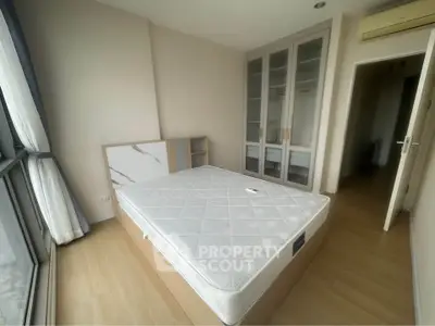 Bright and airy bedroom with large window and modern wardrobe