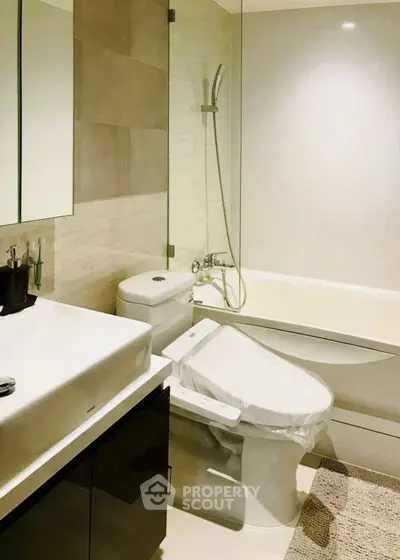 Modern bathroom with sleek fixtures and a bathtub in a contemporary apartment.