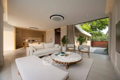 Luxurious open-plan living room with modern furniture and garden view