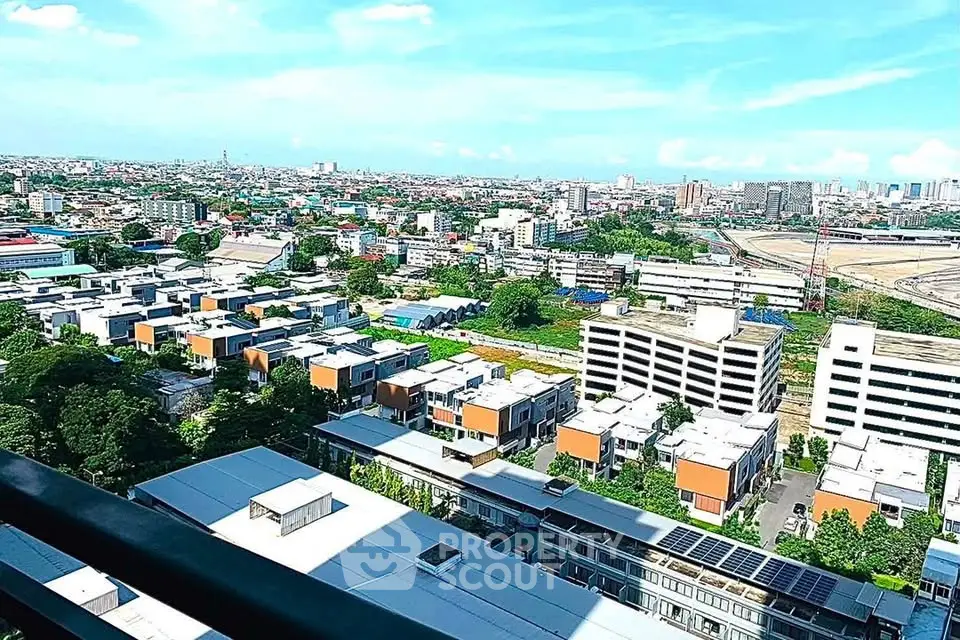 Stunning cityscape view from high-rise balcony overlooking urban landscape and skyline.