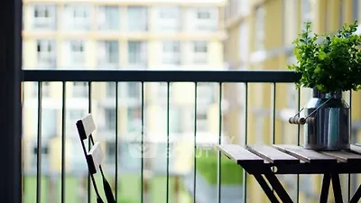 Charming balcony with cozy seating and lush greenery, perfect for relaxation and enjoying the view.