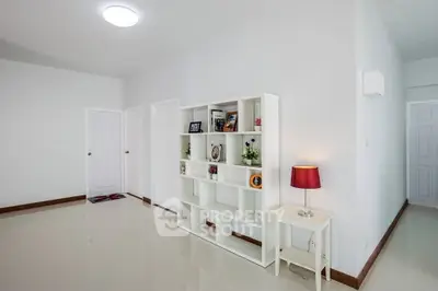 Spacious modern living room with sleek white shelving and elegant decor