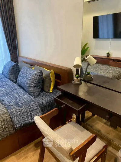 Cozy bedroom with modern furniture and stylish decor, featuring a comfortable bed and a sleek desk area.