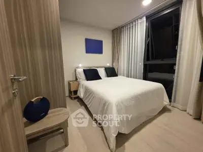 Modern bedroom with cozy lighting and stylish decor in a contemporary apartment.