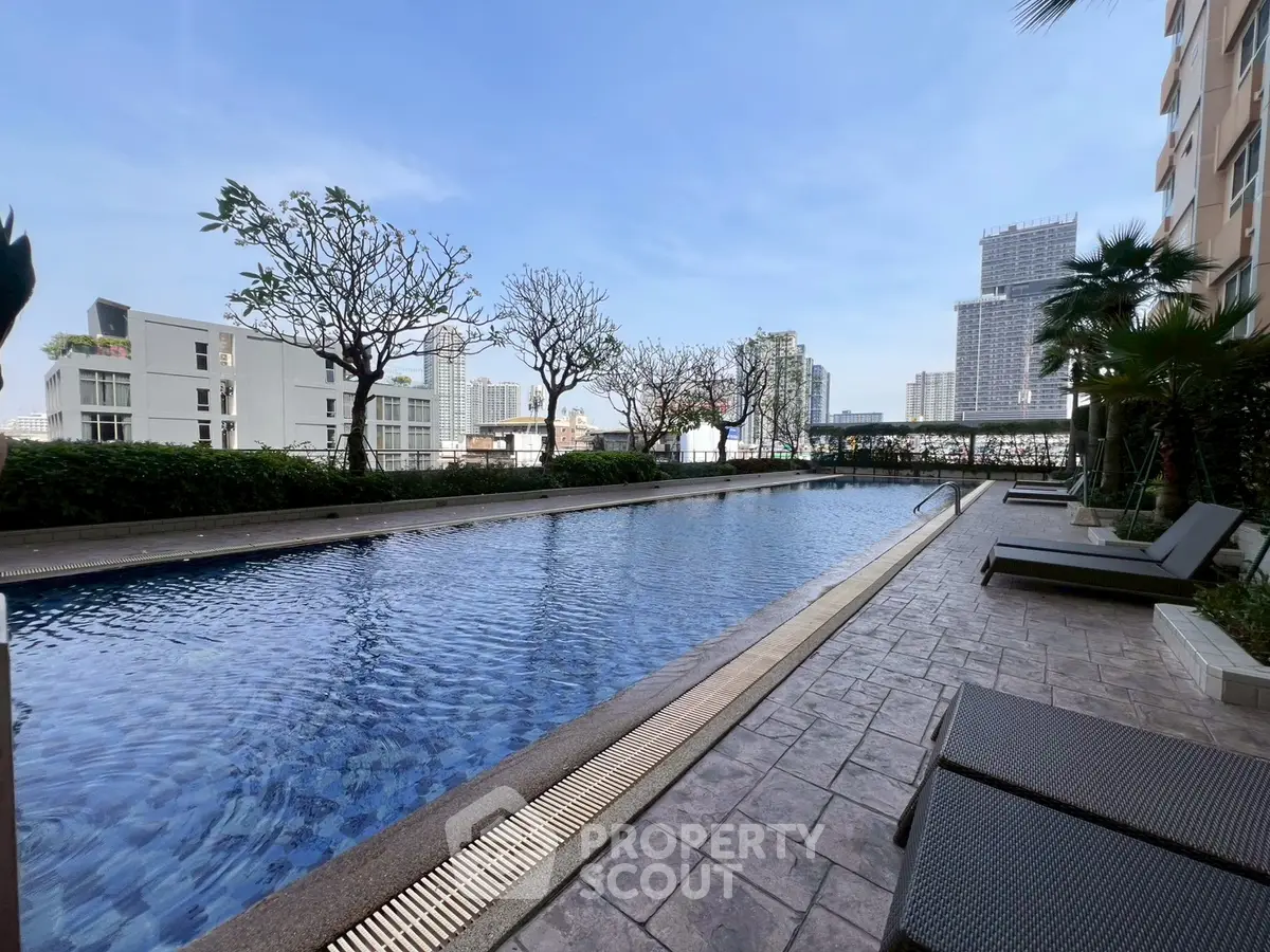 Luxurious rooftop pool with city skyline view, perfect for relaxation and leisure.