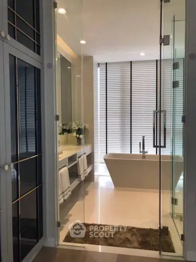 Luxurious modern bathroom with elegant bathtub and large mirrors