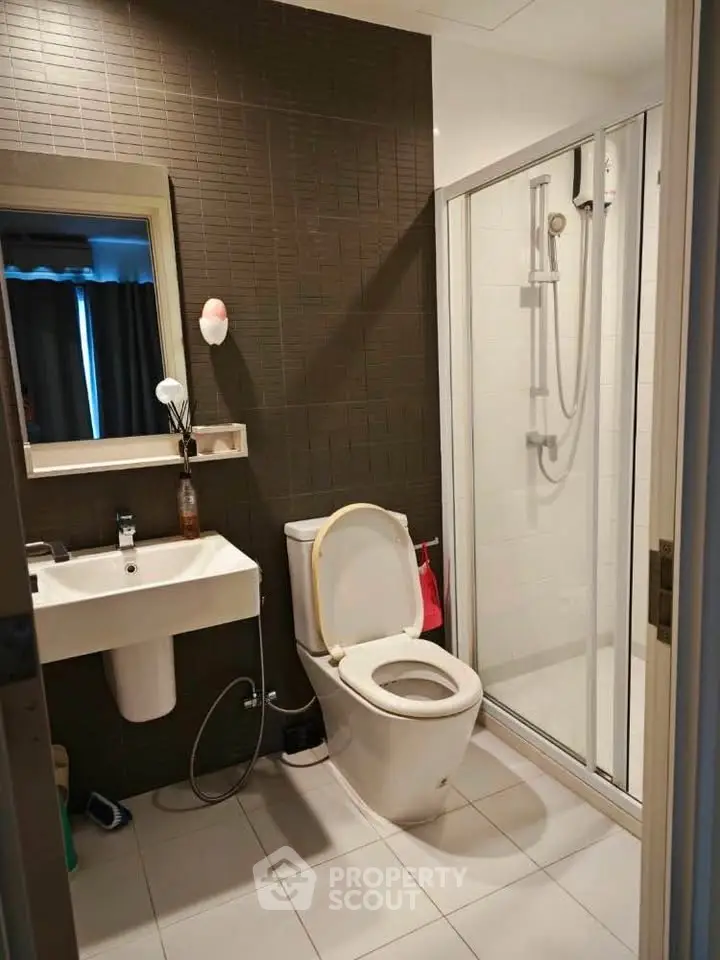 Modern bathroom with sleek shower and contemporary fixtures in a stylish apartment.