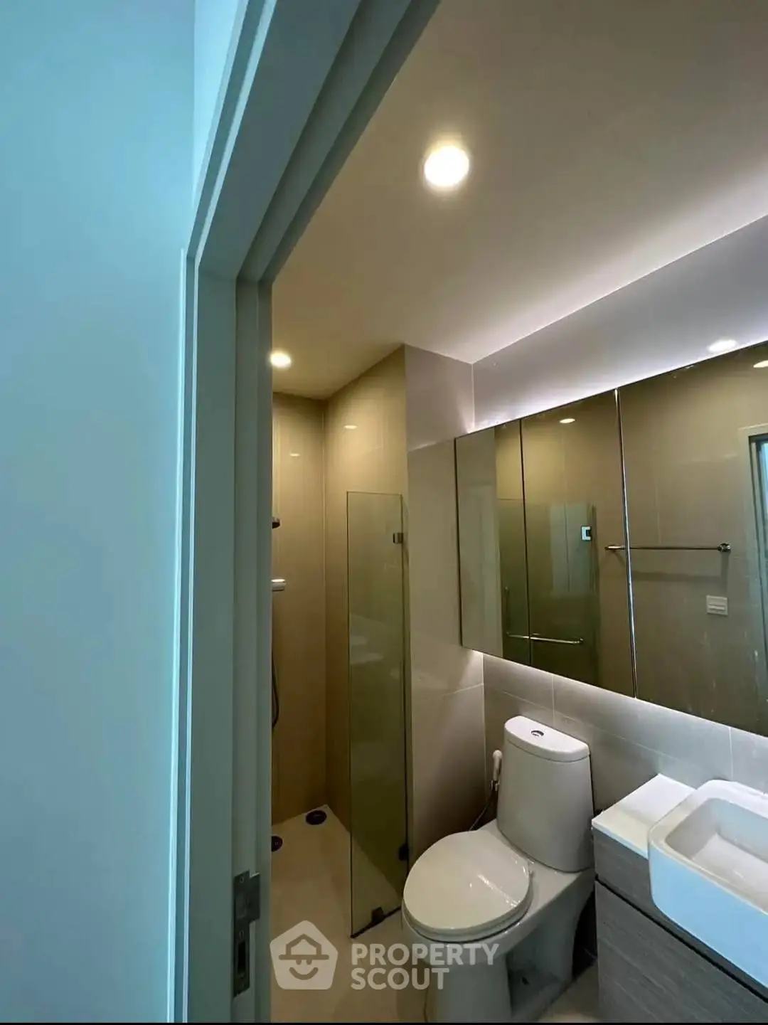 Modern bathroom with sleek fixtures and glass shower enclosure