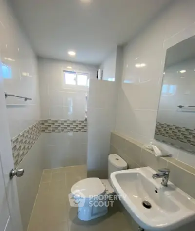 Modern bathroom with sleek white tiles and compact design