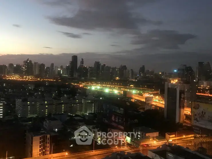 Stunning city skyline view at dusk with illuminated buildings and roads.
