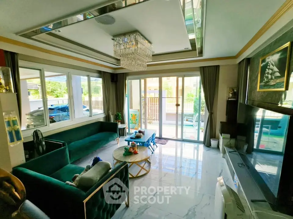 Luxurious living room with elegant decor and large windows offering natural light.