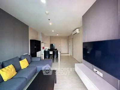 Modern living room with sleek furniture and large TV, perfect for relaxation.