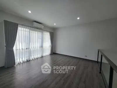 Spacious modern living room with large windows and sleek flooring