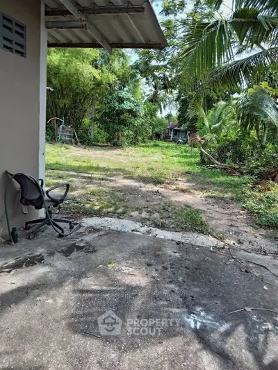 Spacious garden area with lush greenery and potential for landscaping.
