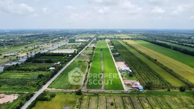 Expansive aerial view of lush green agricultural land and surrounding countryside.