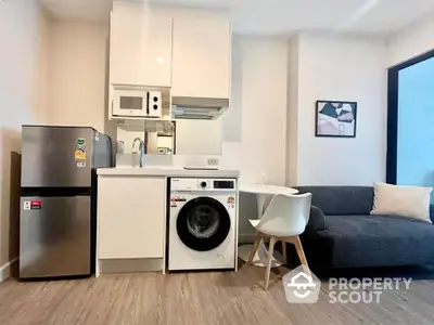 Modern compact kitchen with washing machine and cozy living area