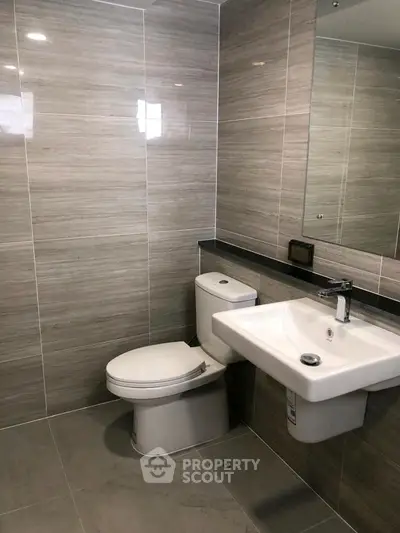 Modern bathroom with sleek fixtures and elegant tile design.