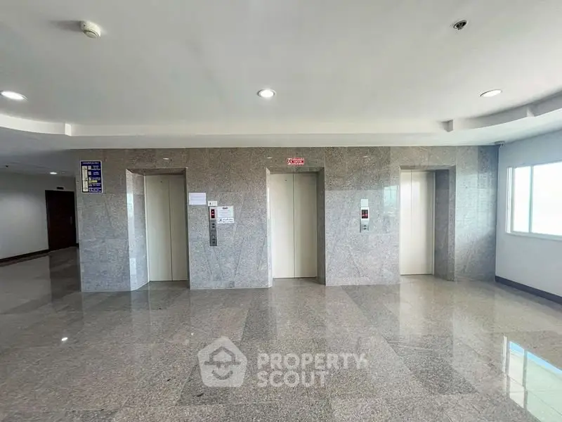 Modern building elevator lobby with polished floors and bright lighting