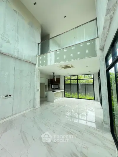 Spacious modern living room with high ceilings and large windows