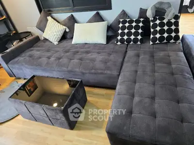 Spacious living room with modern sectional sofa and stylish cushions
