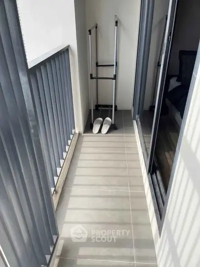 Charming narrow balcony with sleek railing and cozy ambiance, perfect for relaxation.